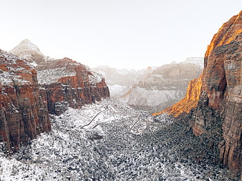 Scenic winter view of snow-dusted cliffs and valleys in Zion National Park. HD wallpaper