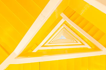 A modern abstract view of a yellow staircase with geometric lines and shapes. HD wallpaper