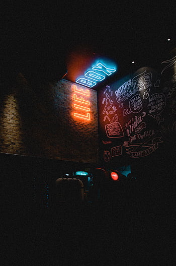 Neon 'LIFE BOX' sign glowing in a dimly lit urban environment with graffiti art. HD phone wallpaper
