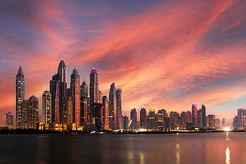 Stunning view of Dubai Marina's skyscrapers against a dramatic sunset sky. HD wallpaper