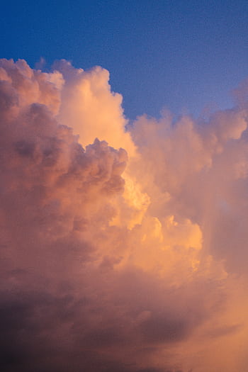 Captivating sunset clouds with dramatic colors against a blue sky. HD phone wallpaper