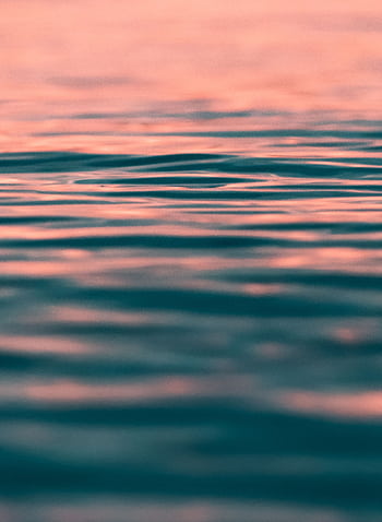 Serene ocean waves with warm sunset hues in Fažana, Croatia. HD phone wallpaper