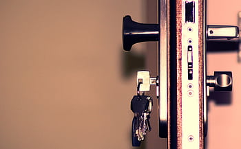 Detailed view of a door lock and keys emphasizing security and access. HD wallpaper