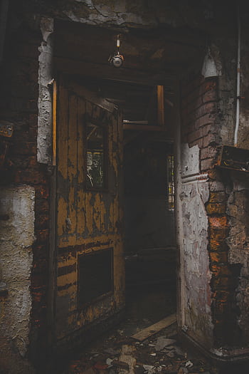 Explore the eerie and decayed remains of an abandoned house in Wales, featuring a broken doorway. HD phone wallpaper