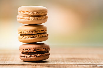 Close-up of stacked macarons showcasing their delicious textures and colors. HD wallpaper