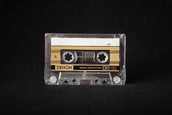 Close-up of a retro cassette tape showcasing nostalgic analog music technology. HD wallpaper