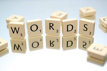 Scrabble tiles spelling 'words' on glass reflecting surface, perfect for language and games themes. HD wallpaper