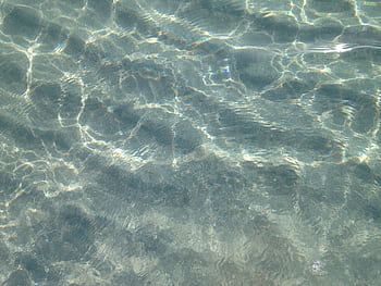 Crystal clear ocean water displaying peaceful ripples and reflections in Boca Raton, Florida. HD wallpaper