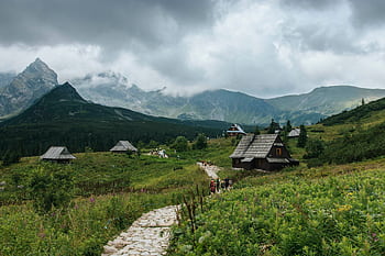Charming wooden houses in the Tatra Mountains near Zakopane, Poland on a cloudy day. HD wallpaper