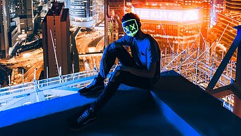 Mask Man Sitting On Top Of Building, neon, mask, graphy HD wallpaper