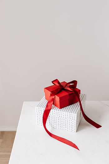 Two gift boxes stacked, topped with a red ribbon, perfect for birtays or celebrations. HD phone wallpaper
