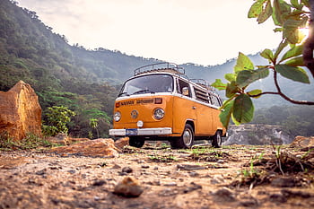 A classic orange Volkswagen van parked in a que setting in Alegría, El Salvador. HD wallpaper