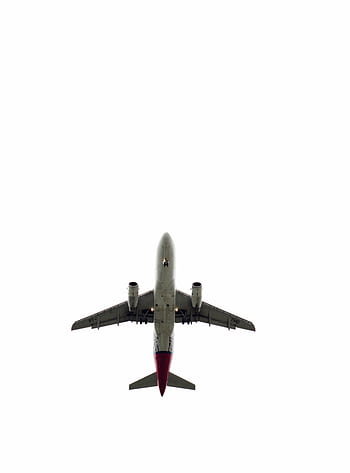 Silhouette of a commercial airplane against a minimalistic sky, symbolizing modern air travel. HD phone wallpaper