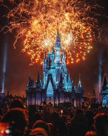 Enchanting fireworks illuminate the iconic castle at night, creating a magical celebration atmosphere. HD phone wallpaper