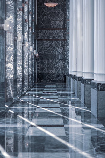 Modern marble hallway with tall columns and reflective surfaces illuminated by daylight. HD phone wallpaper