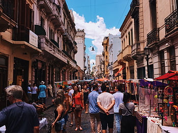 Bustling San Nicolas street market in Buenos Aires with stalls and crowds under a clear sky. HD wallpaper
