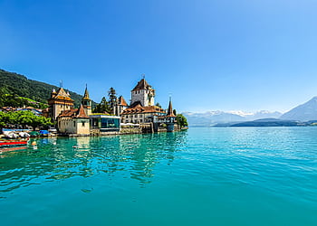 Experience the enchanting Oberhofen Castle on the turquoise shores of Lake Thun in Switzerland. HD wallpaper