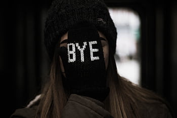 Portrait of a young woman wearing a hat and glove with 'Bye' text, expressing a playful farewell. HD wallpaper