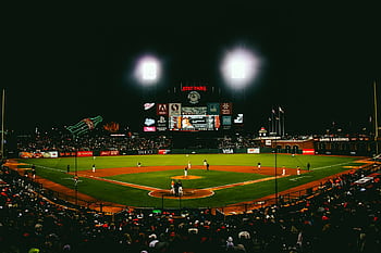 Exciting evening baseball game with fans at AT&T Park stadium under bright lights. HD wallpaper