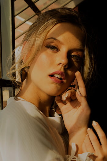 Striking portrait of a young woman with dramatic lighting and makeup indoors. HD phone wallpaper