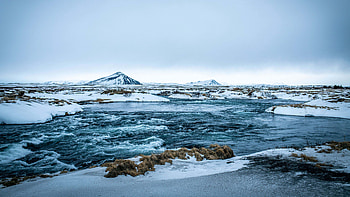 Snow Covered Frozen Stones Glacier Water Ocean Waves Mountain Under Blue Sky Nature HD wallpaper