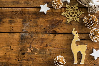 A vintage flatlay of Christmas decorations on rustic wooden planks, perfect for seasonal themes. HD wallpaper