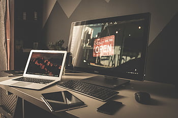 Stylish and organized workspace featuring a laptop, monitor, and digital devices on a desk. HD wallpaper