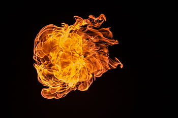 Captivating flame against a dark backdrop, perfect for dramatic themes. HD wallpaper
