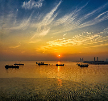 Sunset, boats, yellow sky, silhouette HD wallpaper