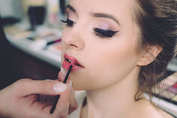 Close-up of an elegant woman having makeup applied, highlighting fashion and beauty. HD wallpaper