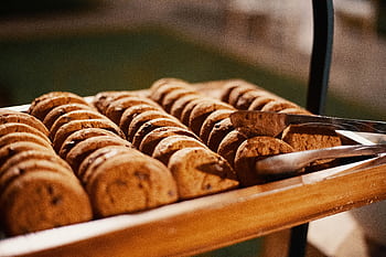 Close-up of freshly baked chocolate chip cookies on a wooden tray, indoors. HD wallpaper