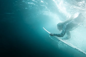 Dynamic underwater shot of a woman surfing at Bronte Beach, Australia. HD wallpaper
