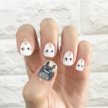 Charming Totoro-themed nail art design featuring cute characters on manicured nails against a stone wall background. HD phone wallpaper