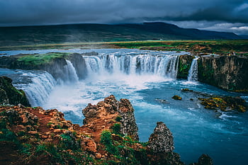 Discover the breathtaking beauty of Godafoss waterfall cascading in Iceland's stunning landscape. HD wallpaper