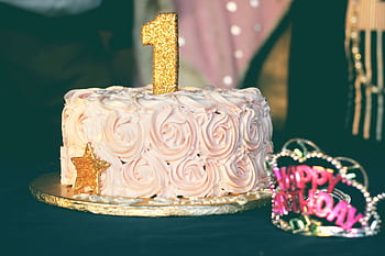A beautiful first birtay cake adorned with pink rosette frosting and golden decorations. Perfect for celebrations. HD wallpaper