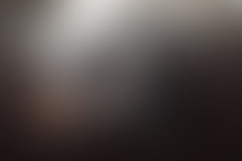 A dark and moody abstract with soft gradient blur, conveying mystery and depth. HD wallpaper