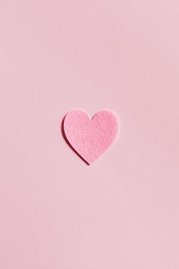 A simple pink felt heart on a light pink background, perfect for Valentine's Day themes. HD phone wallpaper
