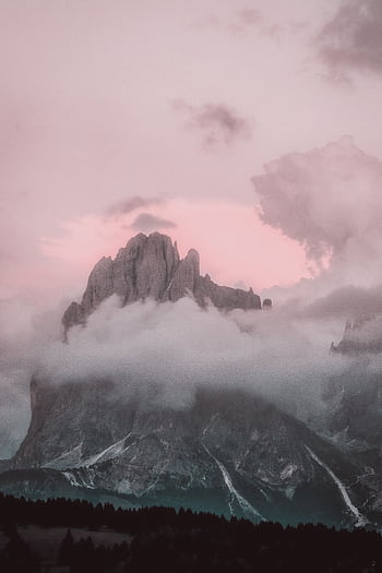Breathtaking twilight view of a misty mountain peak surrounded by clouds. HD phone wallpaper