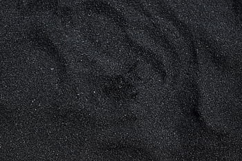Close-up of black sand texture from Waimea Beach in Hawaii. Ideal for backgrounds. HD wallpaper