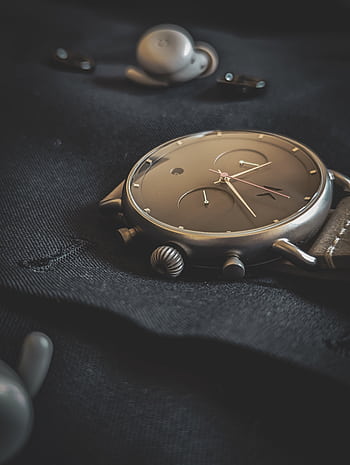 Stylish wristwatch lying on a dark fabric, emphasizing luxury and elegance. HD phone wallpaper