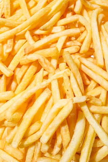A close-up of delicious crispy French fries with a vibrant yellow background. HD phone wallpaper