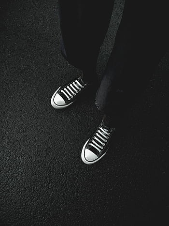 High-angle view of black sneakers on asphalt, showcasing urban fashion and trendiness. HD phone wallpaper