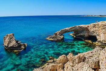 Idyllic coastal view of Cyprus arch and turquoise sea, perfect for summer travel inspiration. HD wallpaper