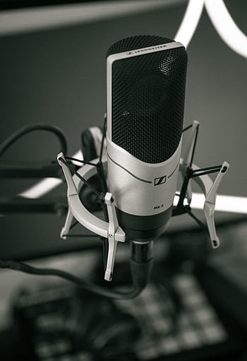 Close-up of a sleek micro setup in a modern recording studio, capturing sound with precision. HD phone wallpaper