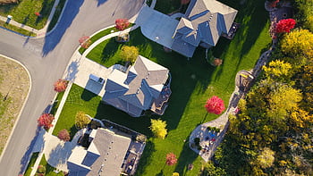A que aerial view showcasing suburban homes with vibrant gardens and tree-lined streets. HD wallpaper