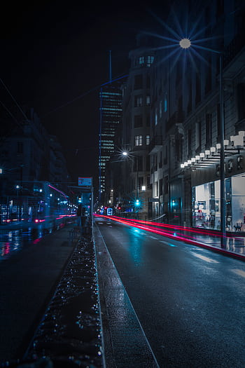 Long exposure capturing light trails on a wet night city street. HD phone wallpaper