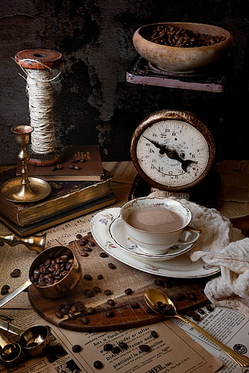 Rustic setup with coffee beans, antique scale, and vintage brass accents creating a cozy atmosphere. HD phone wallpaper