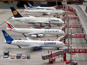 Detailed miniature model of an airport terminal with various aircraft brands on display. HD wallpaper