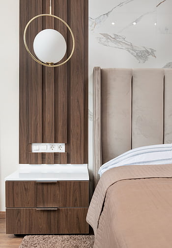Elegant modern bedroom featuring a stylish bedside and contemporary decor with warm tones. HD phone wallpaper