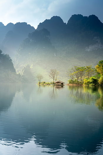 Scenic view of a foggy lake surrounded by lush mountains in Tuyên Quang, Vietnam. HD phone wallpaper